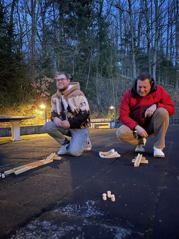 Zwei Personen knien am Boden um etwas zu spielen